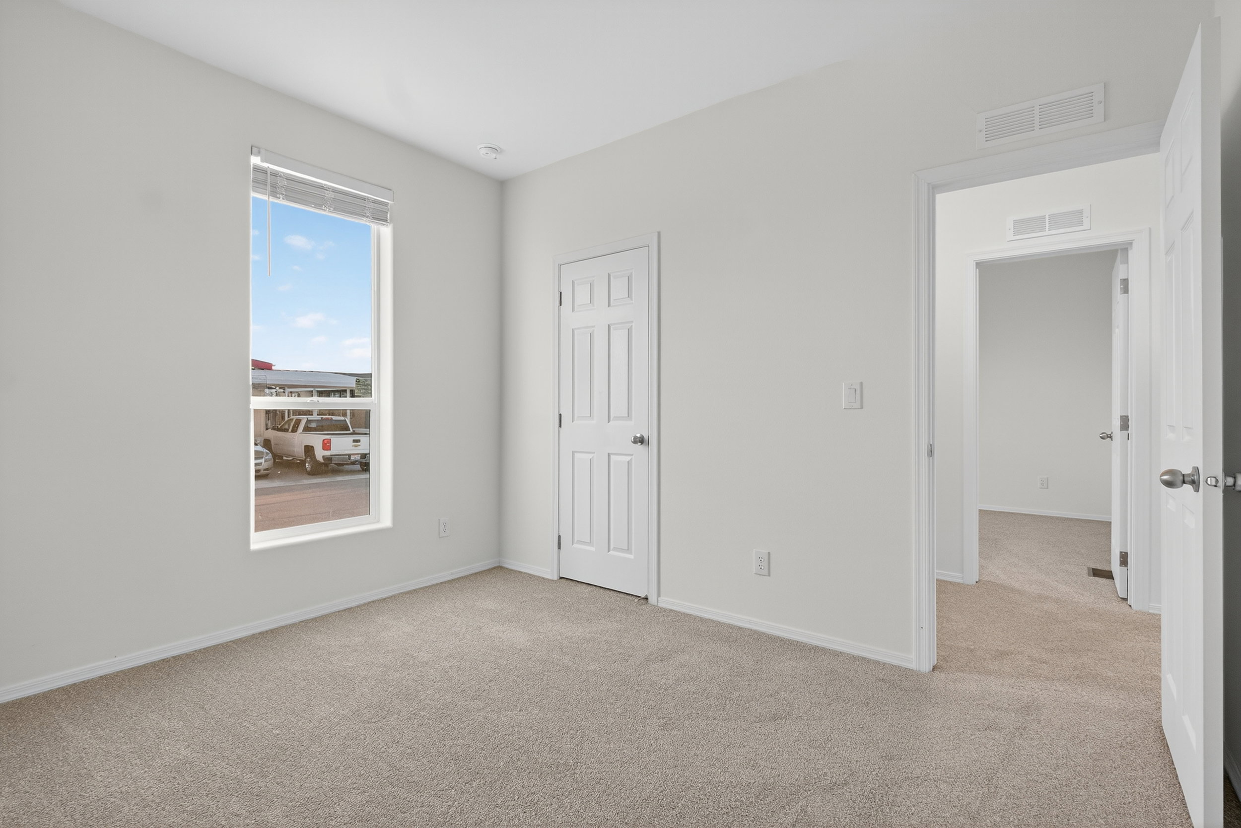 Unfurnished bedroom featuring light carpet