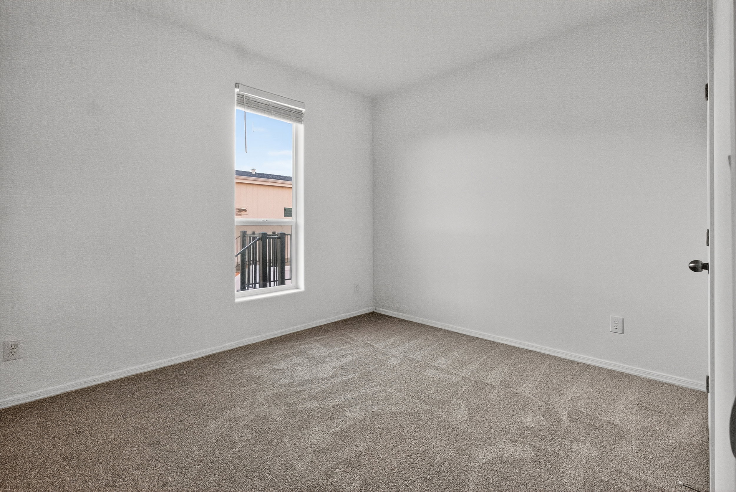 Carpeted empty room featuring baseboards