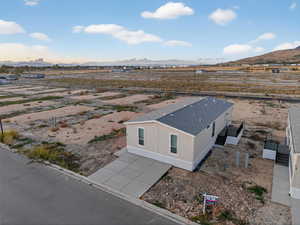 Aerial view of sparsely populated area with a mountain backdrop