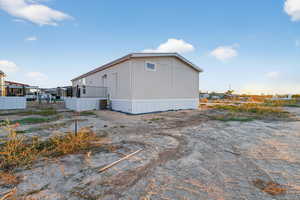 View of side of property with a central air condition unit