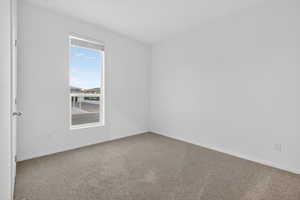 Empty room with carpet and baseboards