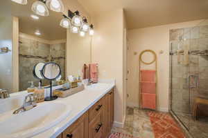 Bathroom with double vanity and a shower stall