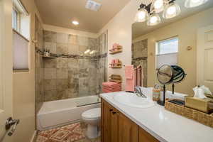 Full bathroom featuring shower / bath combination, vanity, and light tile patterned floors