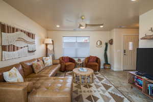 Living room featuring ceiling fan and recessed lighting