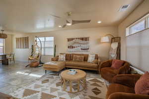 Living area featuring a ceiling fan and recessed lighting