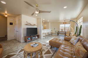 Tiled living room featuring stairway, recessed lighting, and a ceiling fan