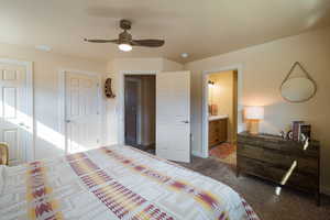 Bedroom featuring a ceiling fan, carpet floors, connected bathroom, and multiple closets