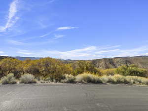 View of asphalt street featuring a mountain view