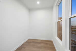 Unfurnished room featuring wood finished floors and recessed lighting