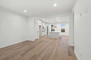 Unfurnished living room with recessed lighting and light wood-style floors