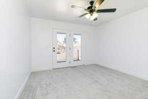 Empty room with light colored carpet and ceiling fan