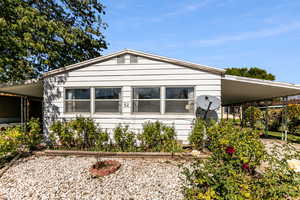 View of front of house with an attached carport
