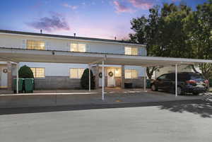 View of front of property with brick siding and covered parking