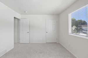 Unfurnished bedroom with carpet and a textured ceiling