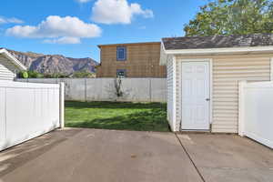 View of patio / terrace with a mountain view and a storage shed