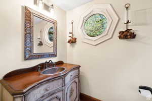 Bathroom featuring vanity and baseboards