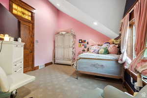Bedroom with vaulted ceiling, light carpet, and recessed lighting