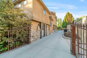 View of property exterior featuring stucco siding and a gate