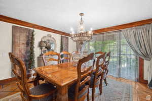 Dining area with a chandelier and a textured ceiling