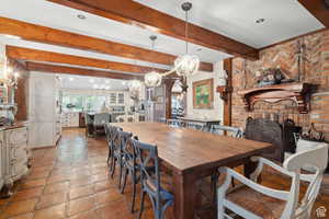 Dining space with a chandelier and beam ceiling
