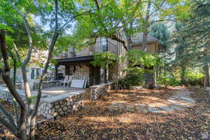 Back of property featuring stone siding