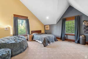 Bedroom featuring carpet floors, lofted ceiling, and recessed lighting