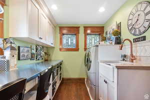Washroom with dark wood finished floors, recessed lighting, and washing machine and dryer