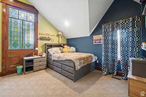 Bedroom with lofted ceiling, light carpet, and recessed lighting
