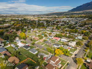 Aerial overview of property's location with a mountain backdrop and nearby suburban area