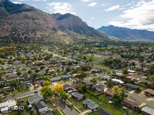 Aerial overview of property's location featuring mountains and nearby suburban area