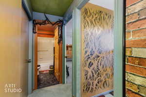 Hall featuring carpet flooring