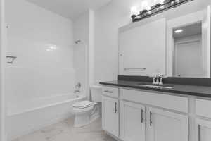 Bathroom with vanity, shower / tub combination, and light marble finish floors
