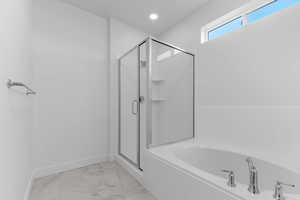 Full bathroom with a marble finish shower, a bath, light marble finish floors, and recessed lighting