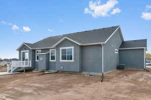 View of front of home featuring stucco siding and a shingled roof