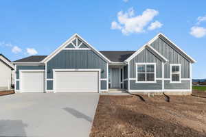 View of front of property featuring a garage and driveway