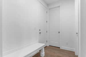 Mudroom featuring wood finished floors and baseboards