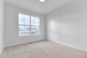 Unfurnished room featuring light colored carpet and baseboards