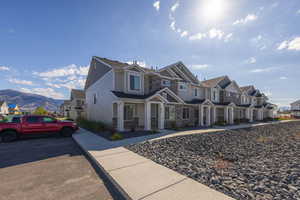 View of front of home featuring a mountain view, a residential view, and covered porch