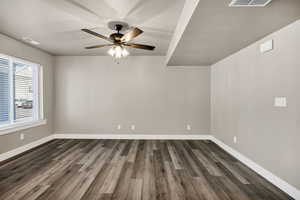 Living room featuring dark wood-type flooring and a ceiling fan