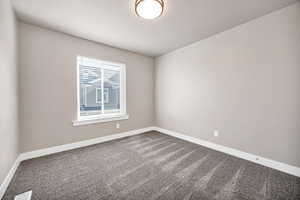 Unfurnished room with carpet flooring