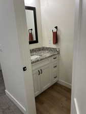 Bathroom with vanity and dark wood-style floors