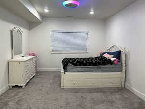 Bedroom with carpet flooring and baseboards