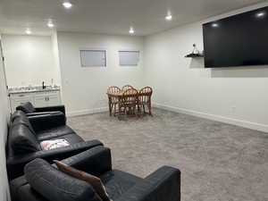 Living room with carpet, recessed lighting, and a textured ceiling