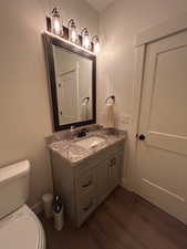 Bathroom featuring vanity and dark wood finished floors