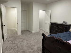 Bedroom featuring light colored carpet and a closet