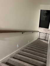 Staircase featuring baseboards
