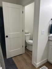 Primary bathroom featuring vanity and dark wood finished floors