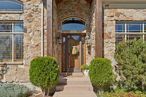 Property entrance featuring stone siding