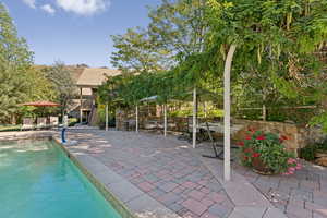 Outdoor pool featuring a patio area, stairs, and outdoor dining area