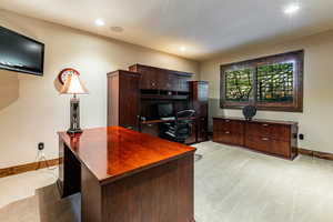 Office area with light carpet and recessed lighting